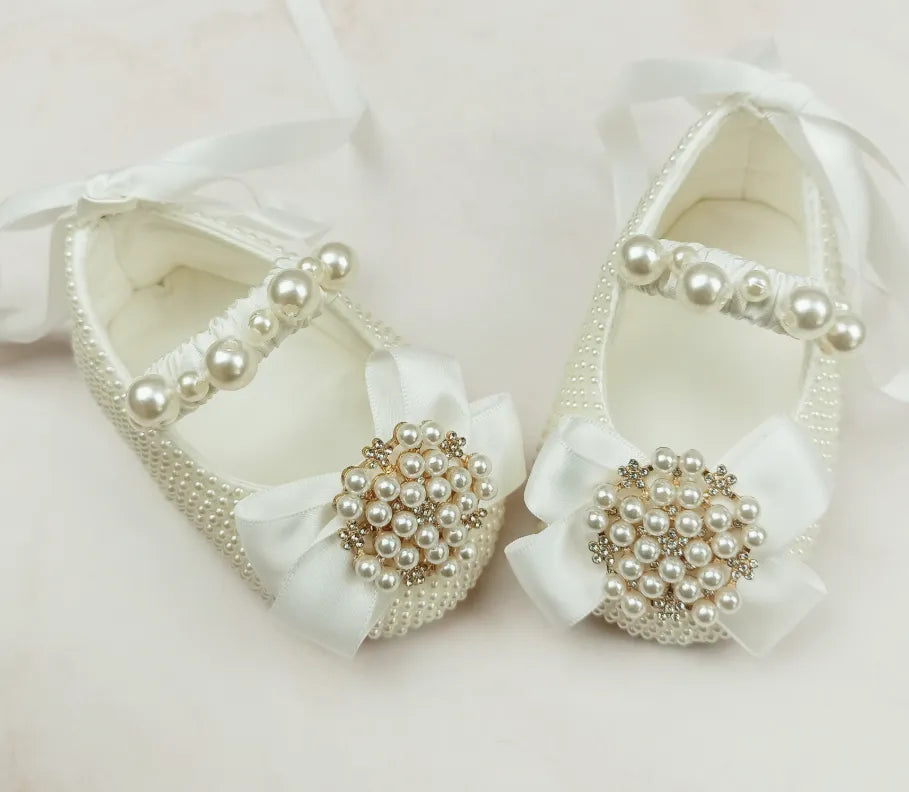 Milky white handmade soft sole cloth princess shoes with pearl detailing and lace-up closure for babies