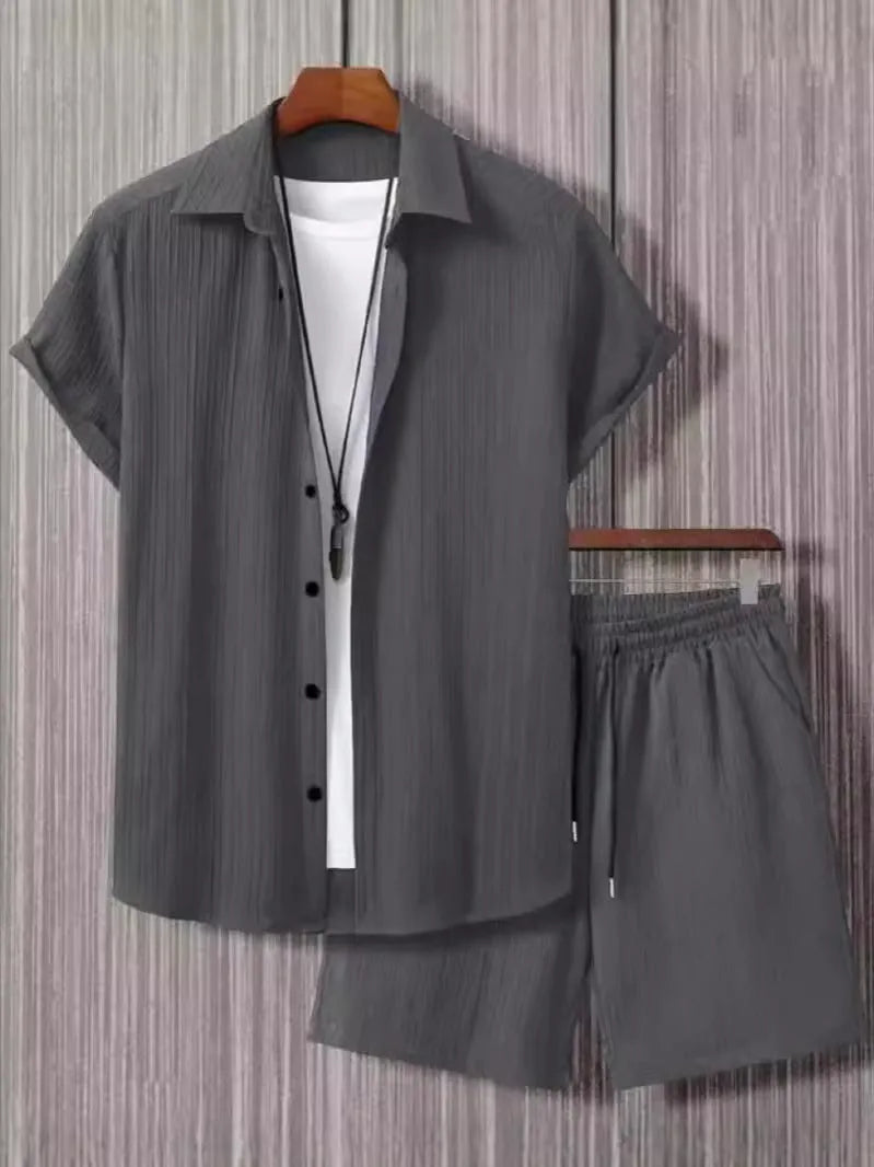 Man wearing a beige jacquard short sleeve suit jacket with matching shorts.