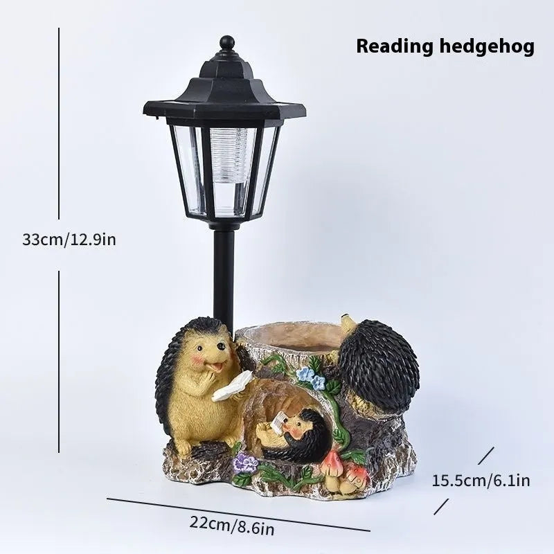 Solar hexagonal garden lamp with decorative resin figurine on plastic base for outdoor pathway lighting