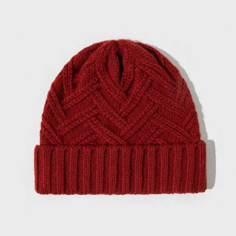 Woman wearing a wool knitted dome crown hat with a totem pattern in ankela red