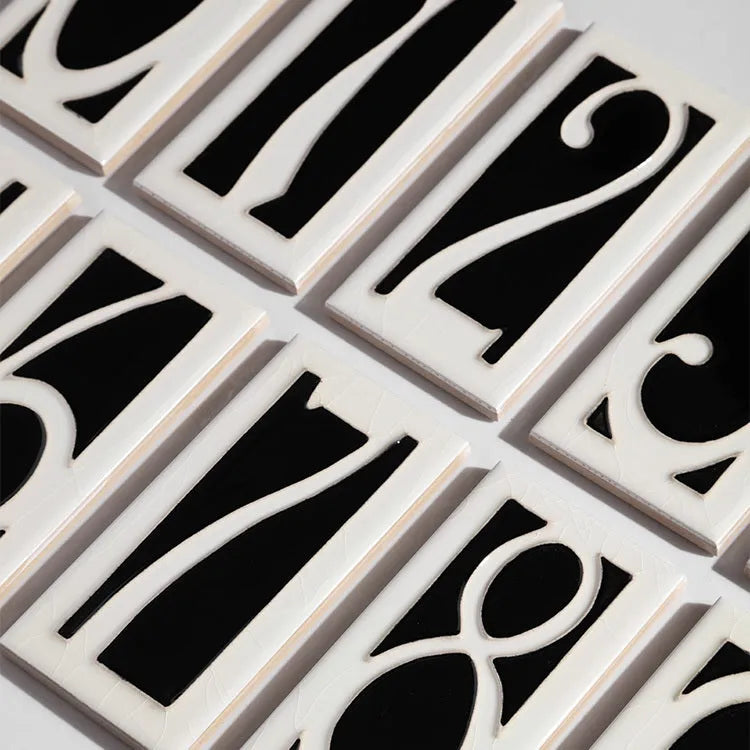 Handmade retro-style ceramic doorplate with a white enamel background and a raised black number 5, shown at 76mm by 152mm.