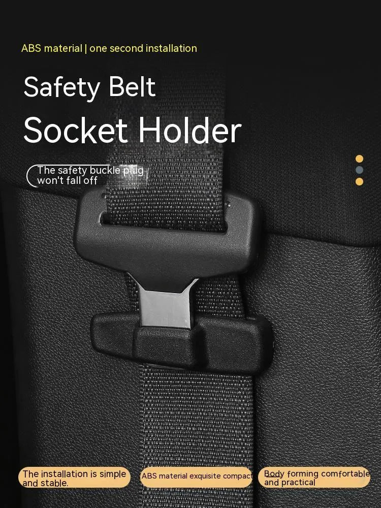 Two black ABS plastic car seat belt stopper clips on vehicle seat