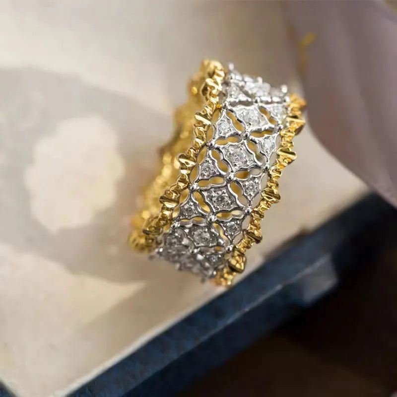 Geometric copper zircon ring with two-tone gold electroplating showing round centre stone
