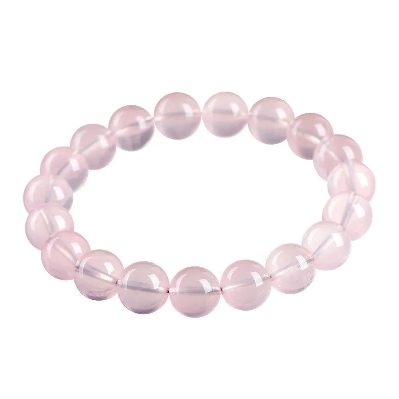 Natural starlight crystal bracelet with round polished pink beads in various size options.
