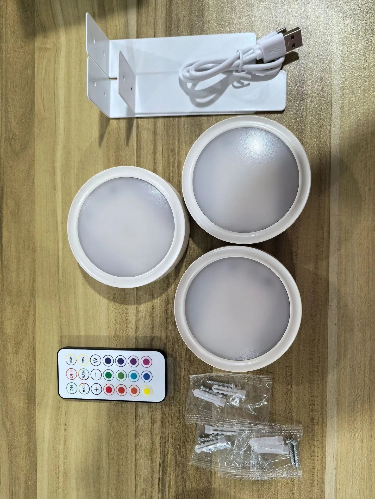 Wireless rechargeable LED painting lamp with magnetic belt attached to a metal frame, remote control nearby.