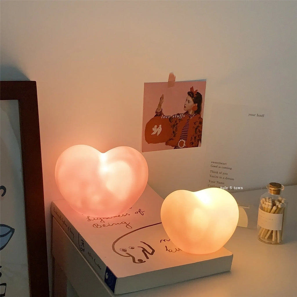 White and pink vinyl atmosphere lamps glowing warmly, shown in small and large size options.