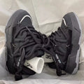 Grey retro clunky sneakers with thick rubber sole and lace-up front, shown on a white background.