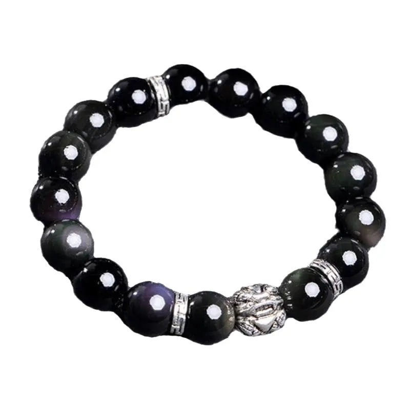 Natural obsidian bead bracelet with Silver 999 details and Cloud Year Of design on a wrist.