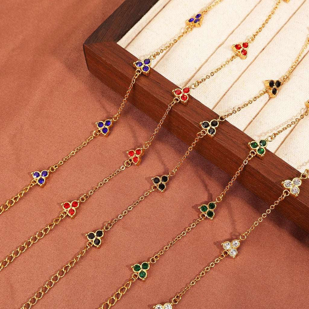 Women's stainless steel geometric bracelet with triangle elements and coloured stone settings