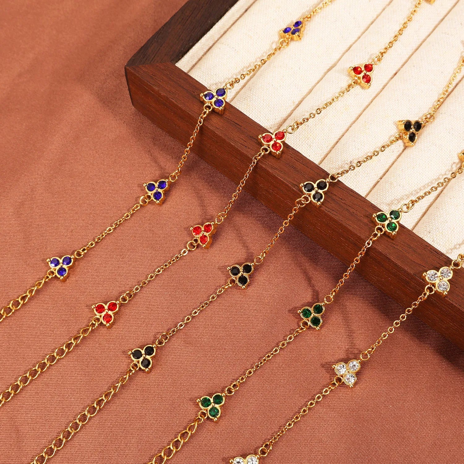 Women's stainless steel geometric bracelet with triangle elements and coloured stone settings