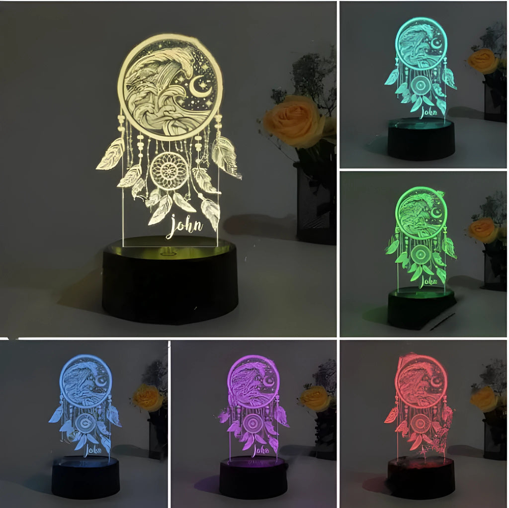 Dream catcher shaped acrylic night light with black base and colourful lighting on wooden surface