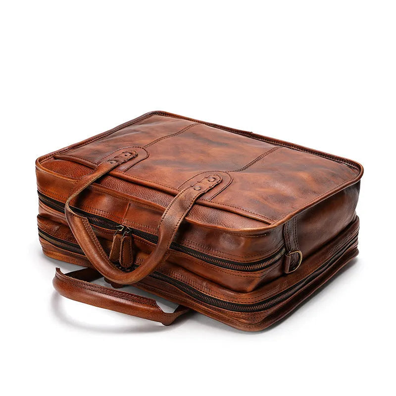 Brown vintage leather men's briefcase showing internal laptop and document pockets