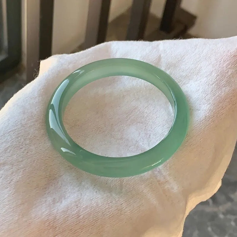 Natural agate wide tyre bracelet showing colour variations including pink, white, blue and green options