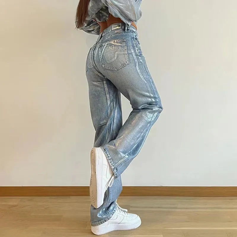 Women's high waist straight leg jeans in washed blue denim with silver contrast details