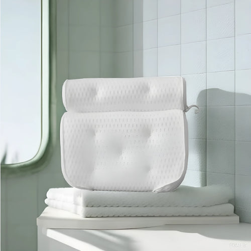 White 4D mesh bathtub pillow with multiple suction cups on a light luxury styled bath mat.