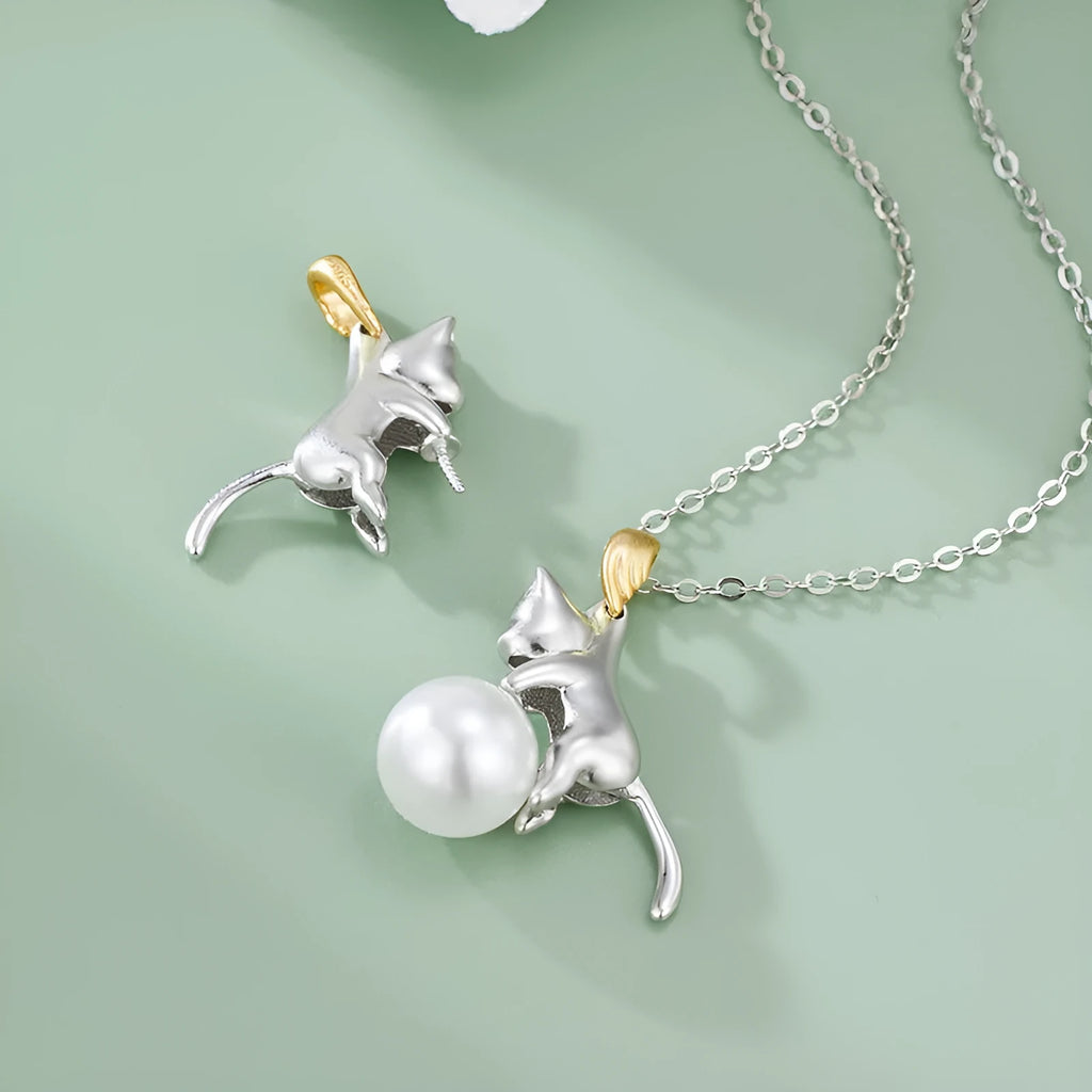 Close-up of a sterling silver cat charm clavicle chain necklace on a model.