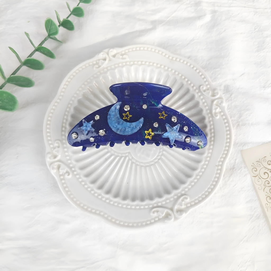 Oversized hair barrette with starry sky pattern in cellulose acetate showing colour options