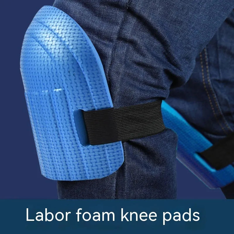 A pair of EVA foam kneepads in black, shown on a hard floor surface.
