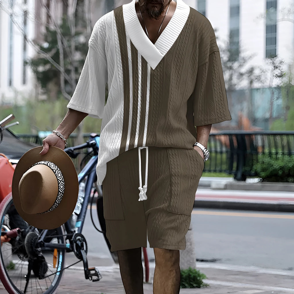 Men's grey printed knitted short-sleeved top and matching shorts on a hanger.