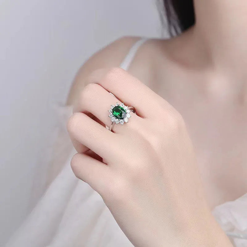 Women's blue moissanite and copper floral ring on a finger, showing zirconium inlay and electroplated colour.