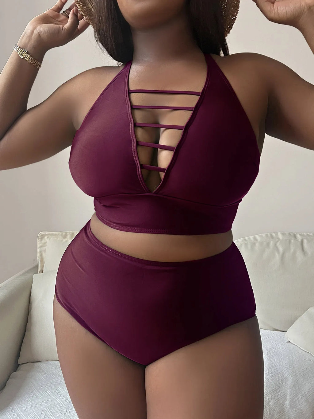 Plus size black halter bikini with cross back design and high waist briefs on mannequin