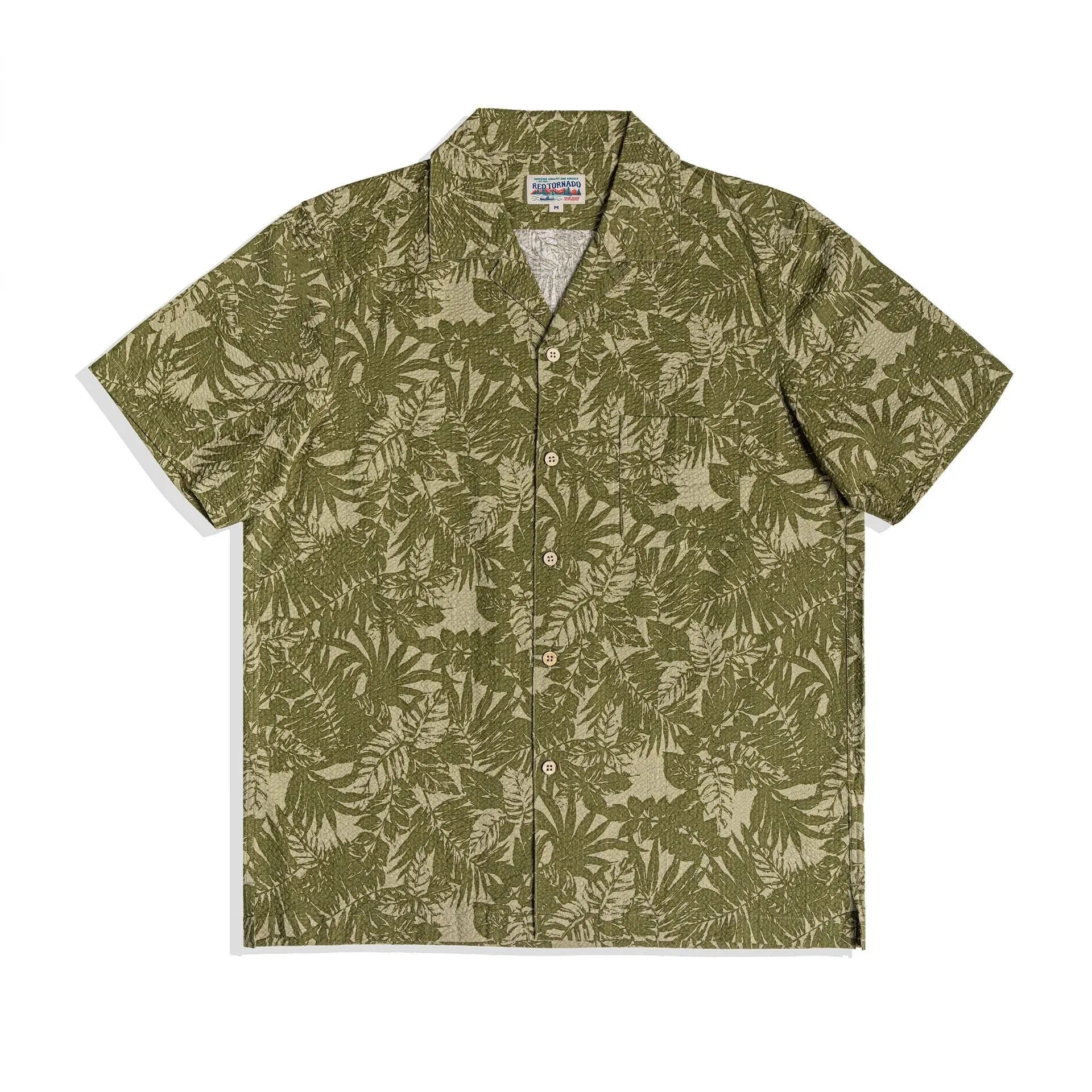 Man wearing a vintage green seersucker shirt with floral print and a Cuban collar.