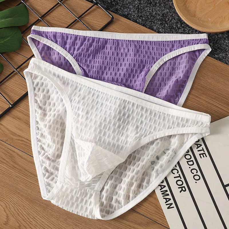 Men's low waist transparent lace underwear in multiple colours on a size chart background.