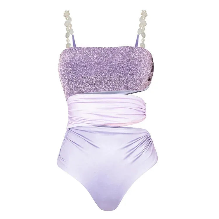 Purple one-piece swimsuit with a separate matching wrap skirt laid flat.