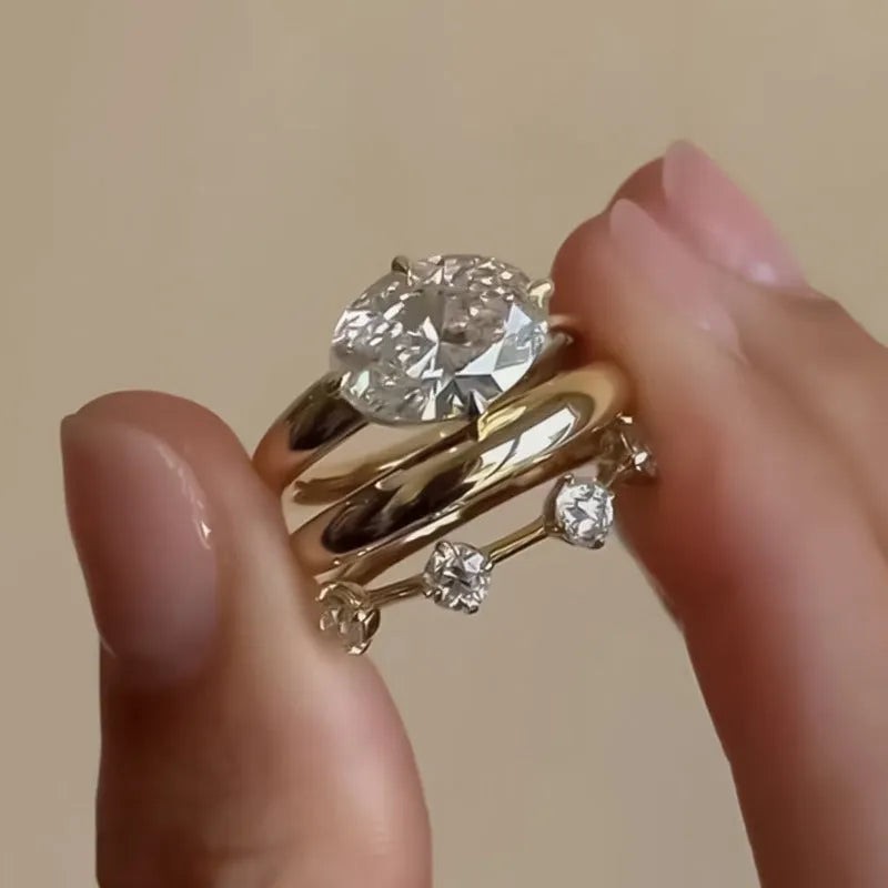 Gold electroplated minimalist ring with a row of small diamonds on silver band