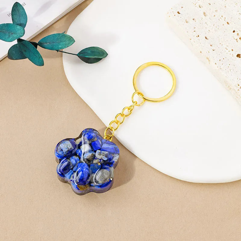 Natural crystal cat's paw keychain pendant in assorted gemstone colours on a keyring.
