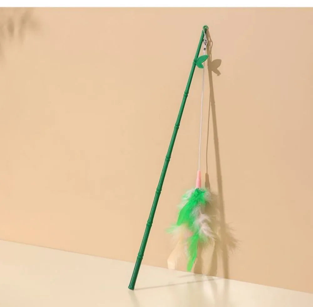 Green interactive cat feather wand toy with bell attachments for feline exercise and training