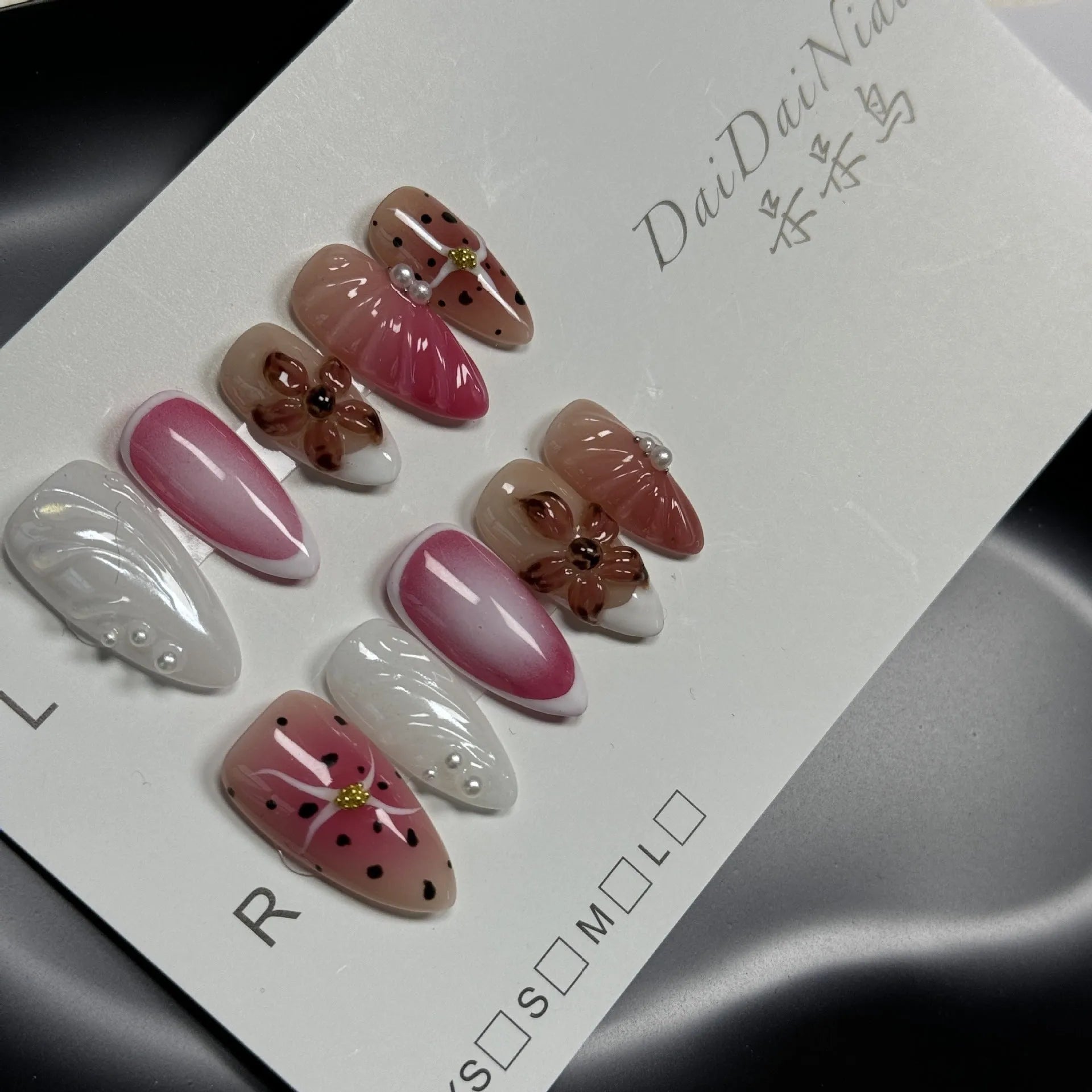 Hand-painted 3D candy pattern false nail art patches in almond shape on a plastic set.