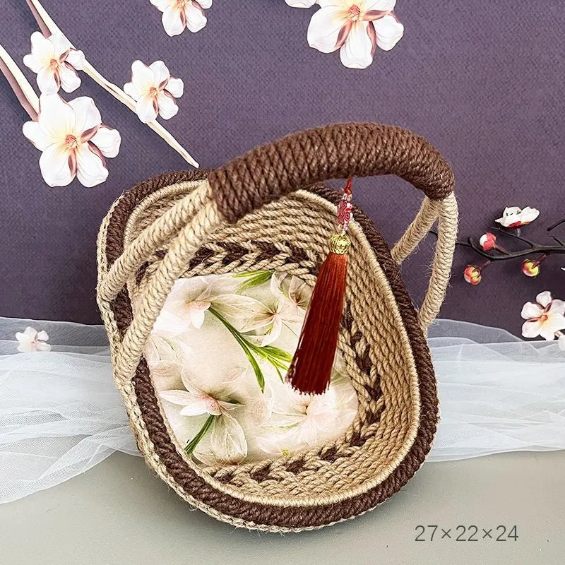 Coffee brown hand-woven straw basket with hemp rope detailing, 19cm long by 12cm wide