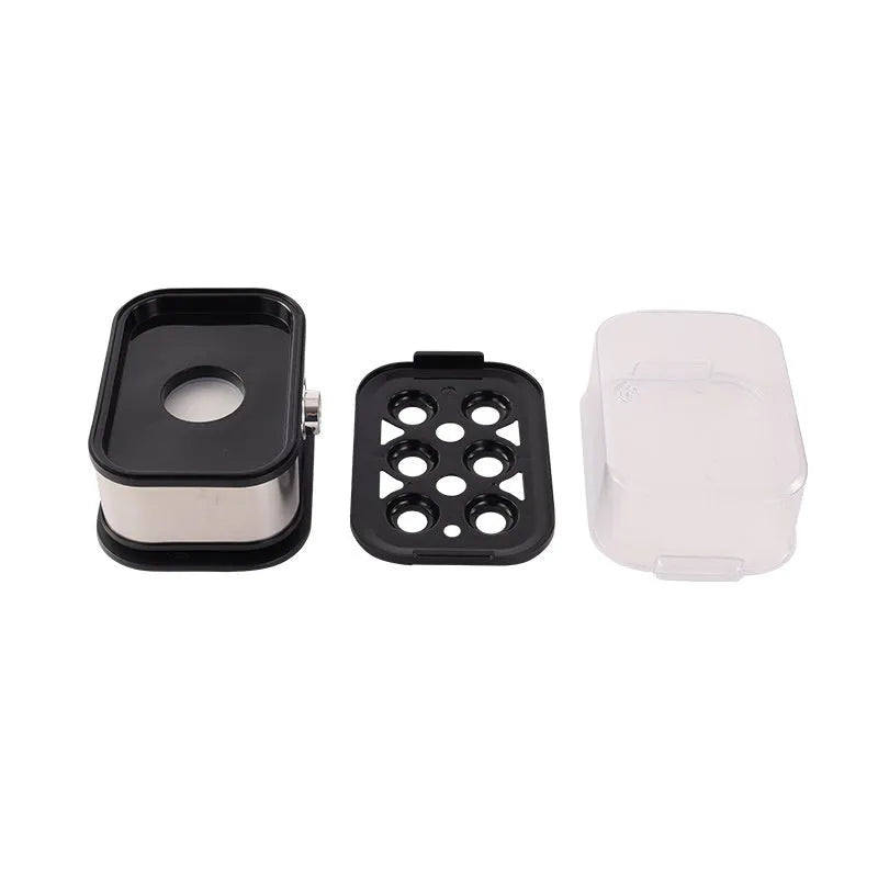 Black portable stainless steel egg boiler with plug adapters for US, UK and EU sockets.