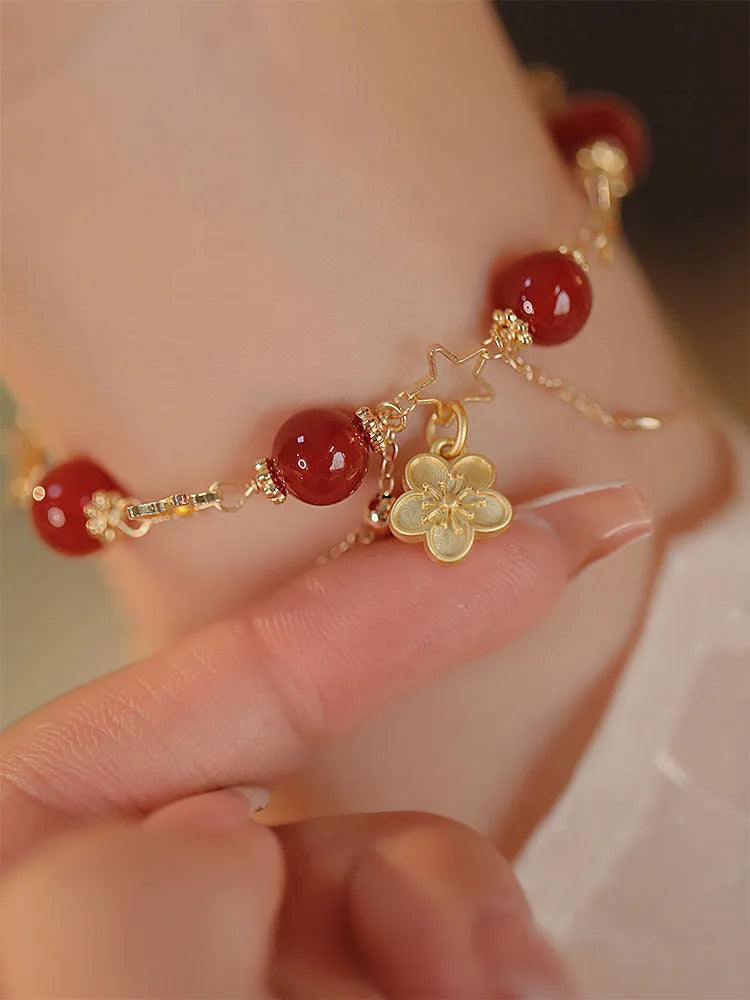 Red agate double layer bracelet with peach blossom charm and manual craftsmanship details
