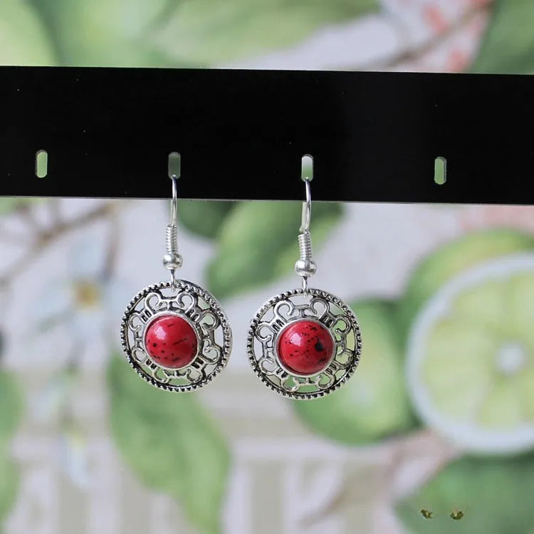 Handmade Miao silver ethnic earrings with turquoise stones in geometric flower disk design