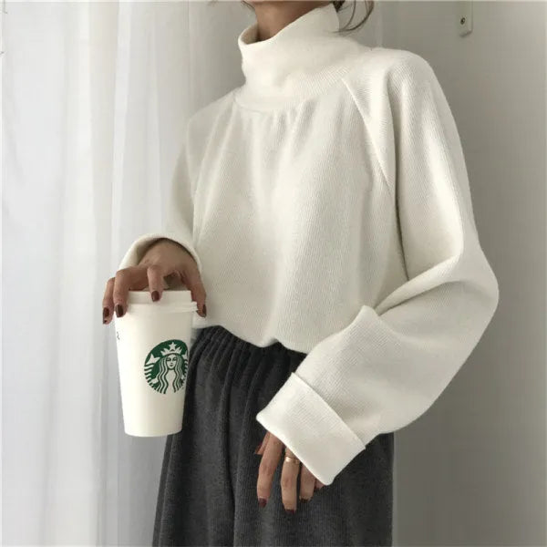 Women's solid colour polyester top with a half-high collar and long sleeves in a loose fit.