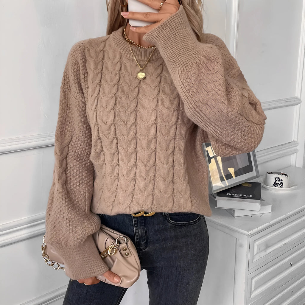Beige women's loose casual sweater with round neck and a subtle twist design detail on the front