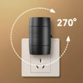 A compact white plug-in night lamp with a rotatable head, shown plugged into a wall socket.