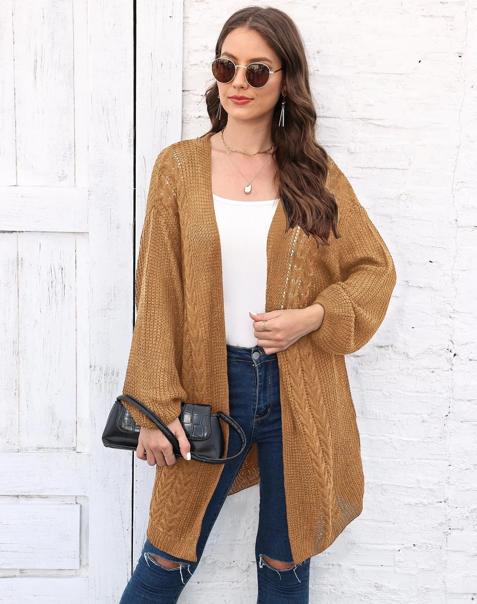 Women's loose acrylic sweater coat in solid colour on hanger