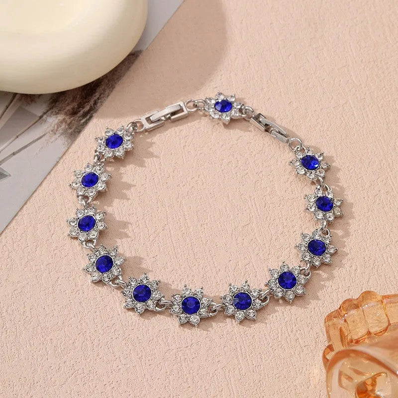 Floral zinc alloy bracelet with electroplated gold or silver finish and gemstone colour variants
