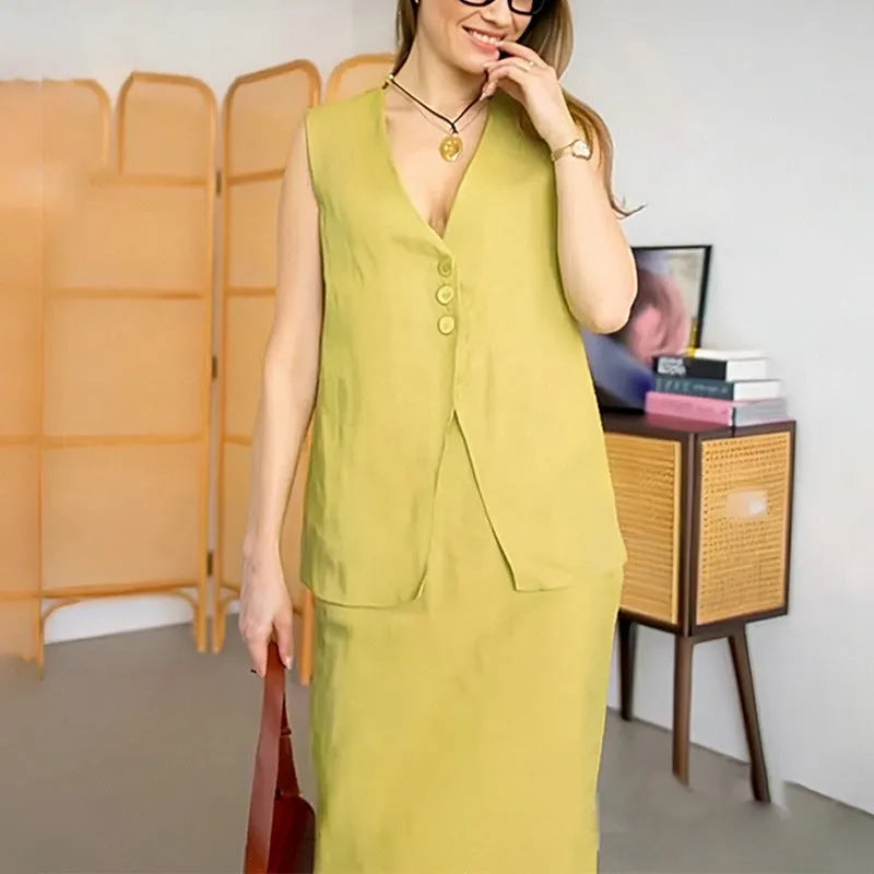 Women's loose fit blue polyester two-piece suit with sleeveless vest and long skirt.