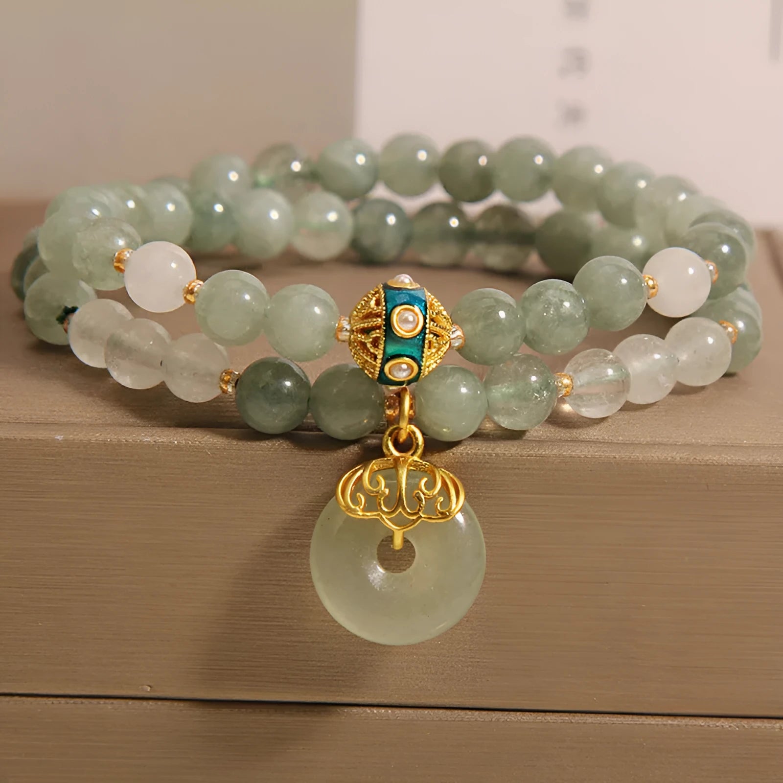 Women's double-layer aventurine jade bracelet with peace buckle closure in emerald green