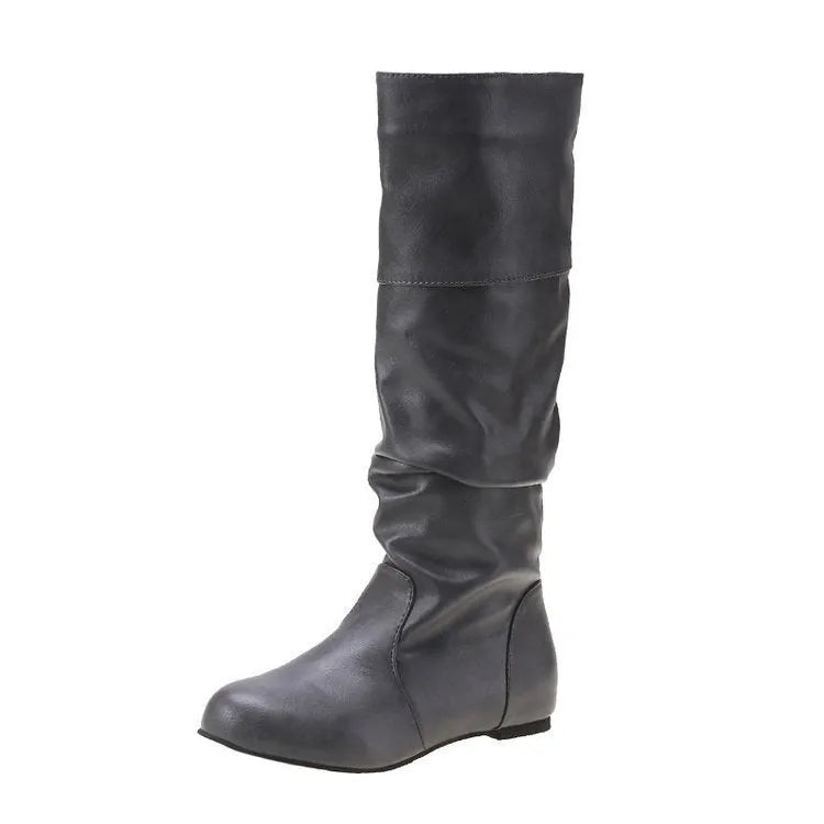 Women's flat ankle boots in black with a round toe and slip-on design on a rubber sole.