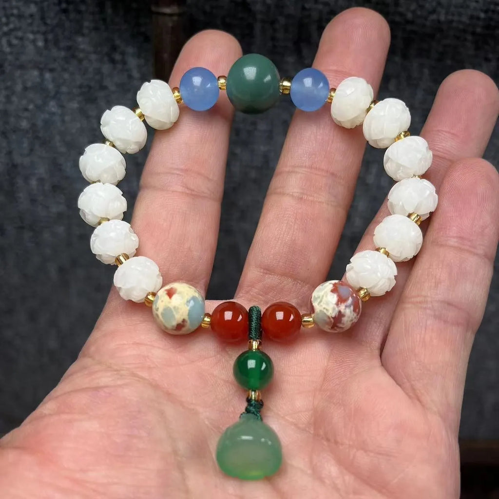 Carved pumpkin and lotus bead bracelet made from Bodhi root with white jade and aventurine details.