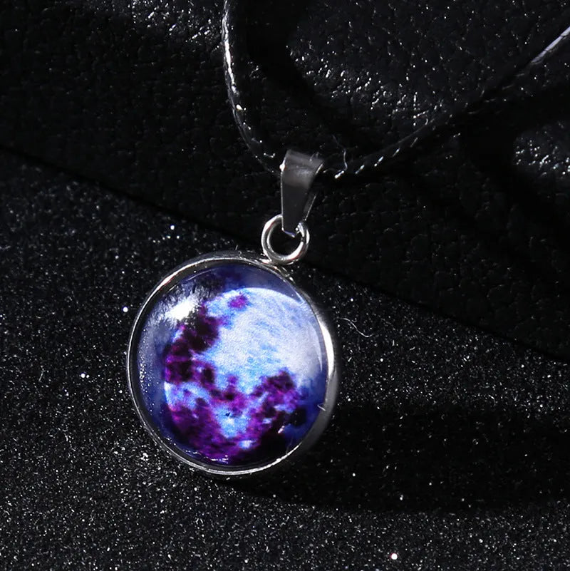 Luminous constellation pendant necklace with adjustable chain on a plain background.