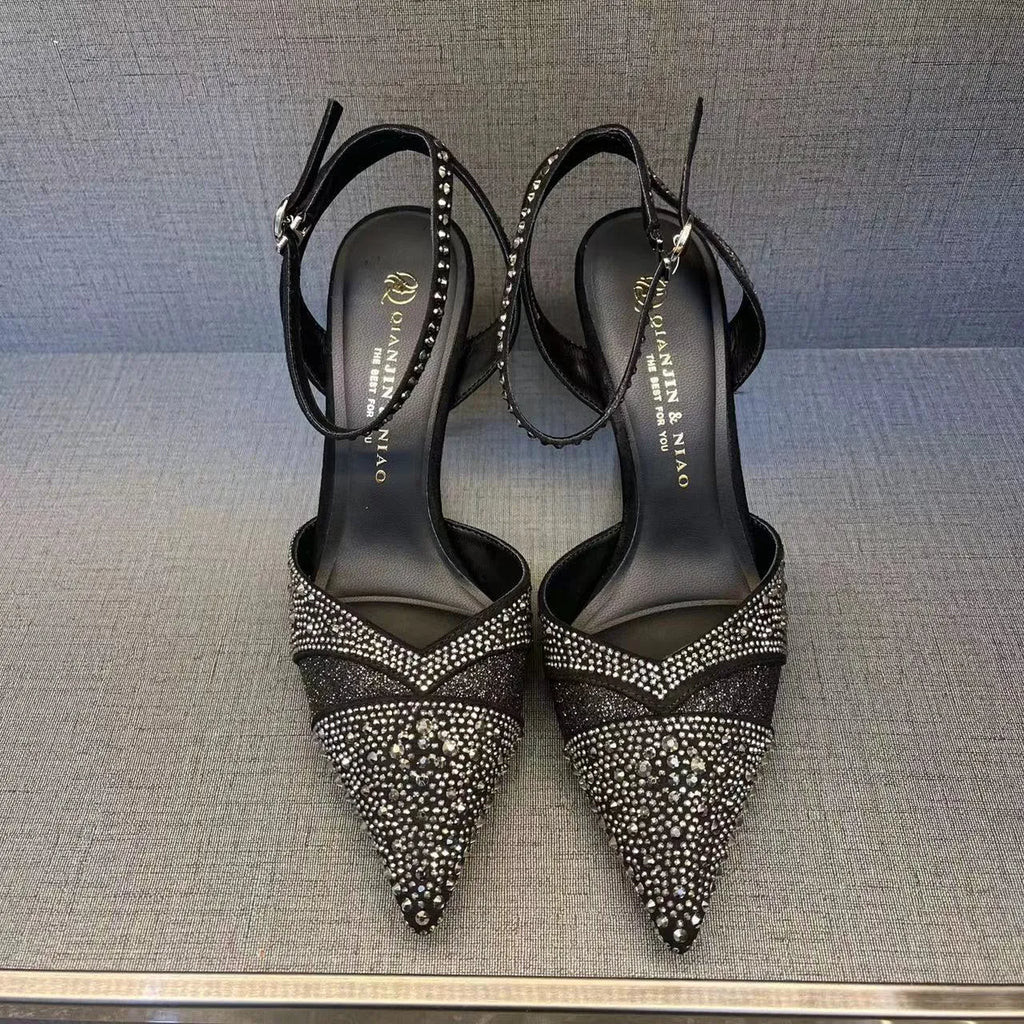 Women's black stiletto high heels with red sole and pointed toe design