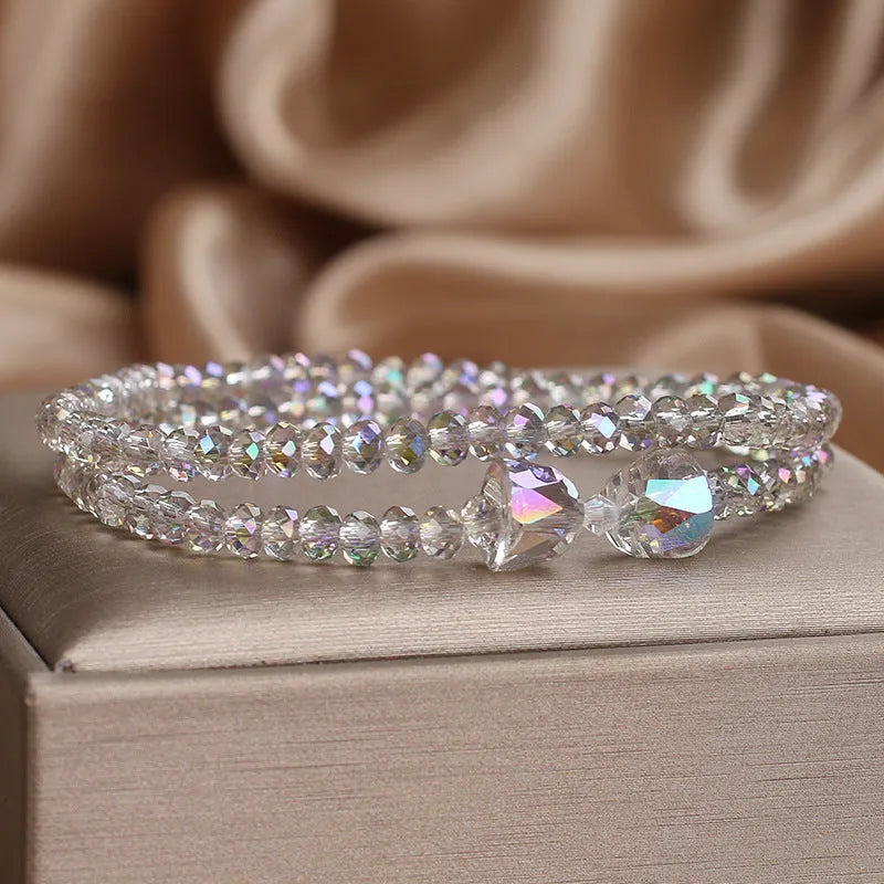 Women's double-circle crystal bow bracelet in white, green, and pink colour options on display