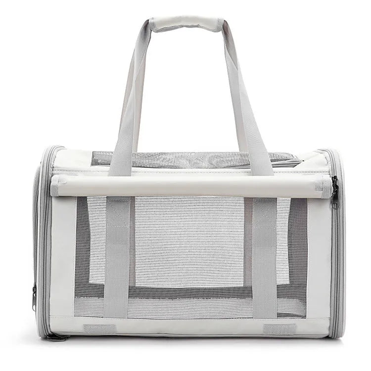 Outdoor portable pet bag in black with transparent panels and mesh sides, folded and shown next to a cat