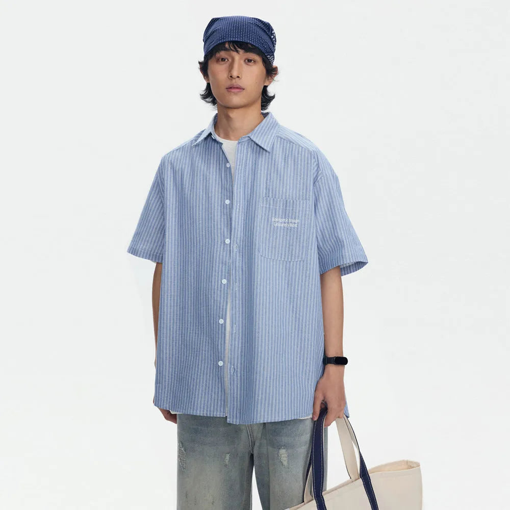 Blue striped short-sleeved shirt overalls with loose fit design on mannequin